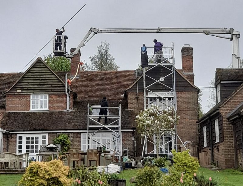 The Roof Moss Cleaners using cherry picker and scaffolding to clean roof safely and professionally in Newbury, Berkshire